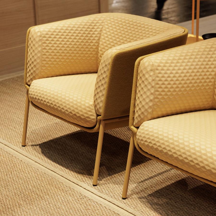 Two mustard Gabriel upholstered lounge chairs with timber frames