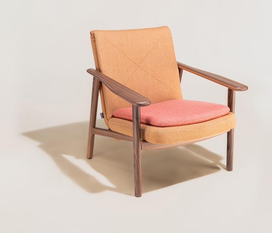 Timber-framed lounge chair upholstered in tan and coral