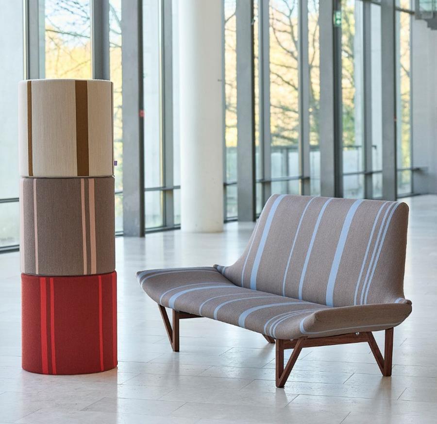 Savak NU: striped sofa and stacked upholstered cubes in a glazed lobby
