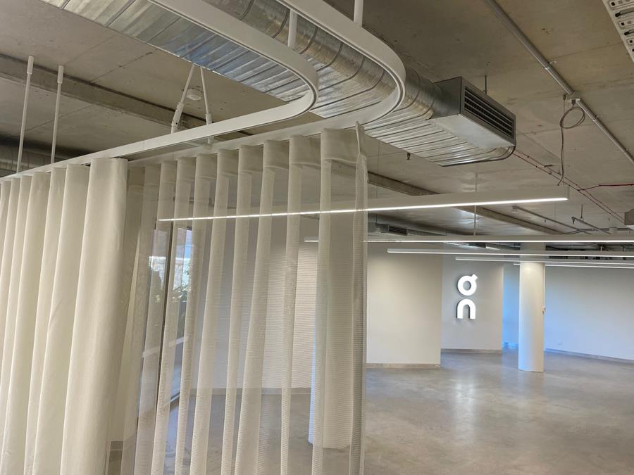 On, Oceania office and showroom: sheer Svensson curtains dividing the open-plan office