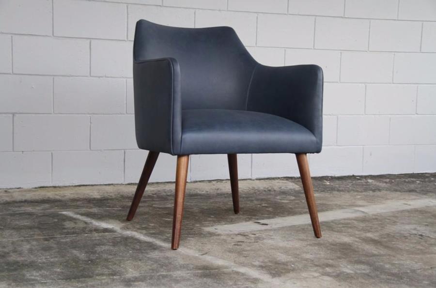 A navy Brusio leather armchair on timber legs