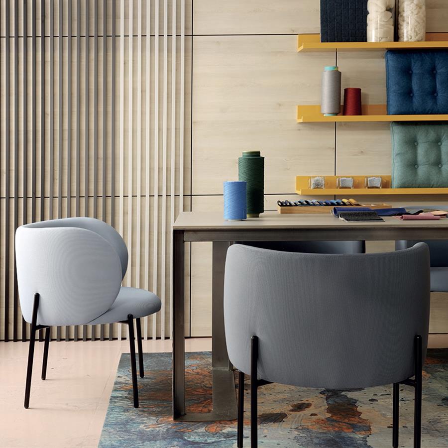 Grey upholstered chairs at a table in a Gabriel room set