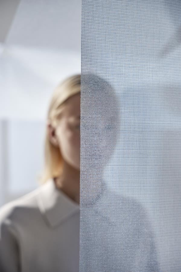 Woman behind a transparent Airy curtain