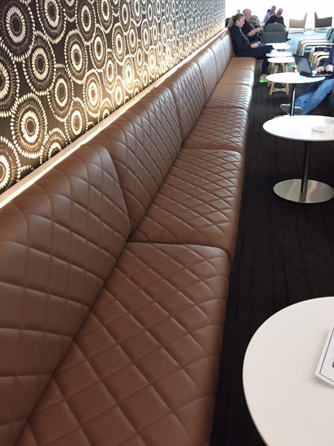 A long channel-stitched leather banquette