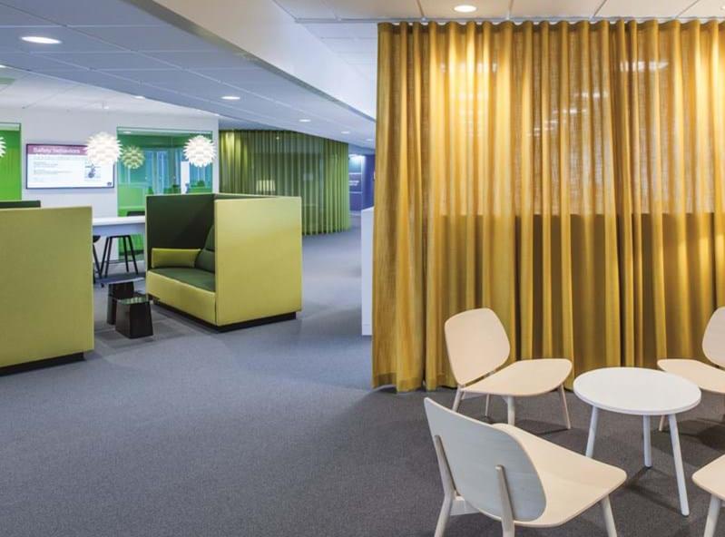 Office with yellow curtains, green booths and meeting tables