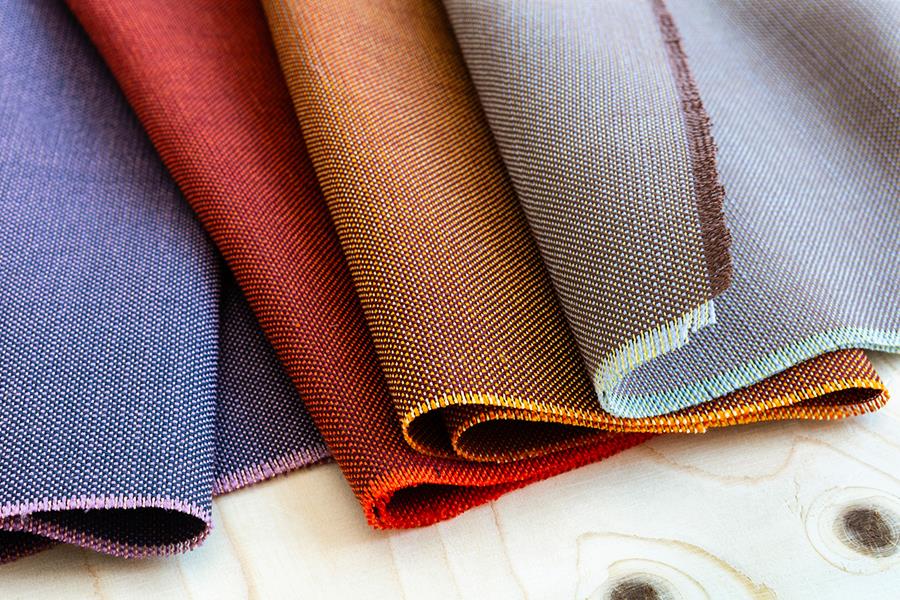 Folded Svensson upholstery samples in blue, orange and red
