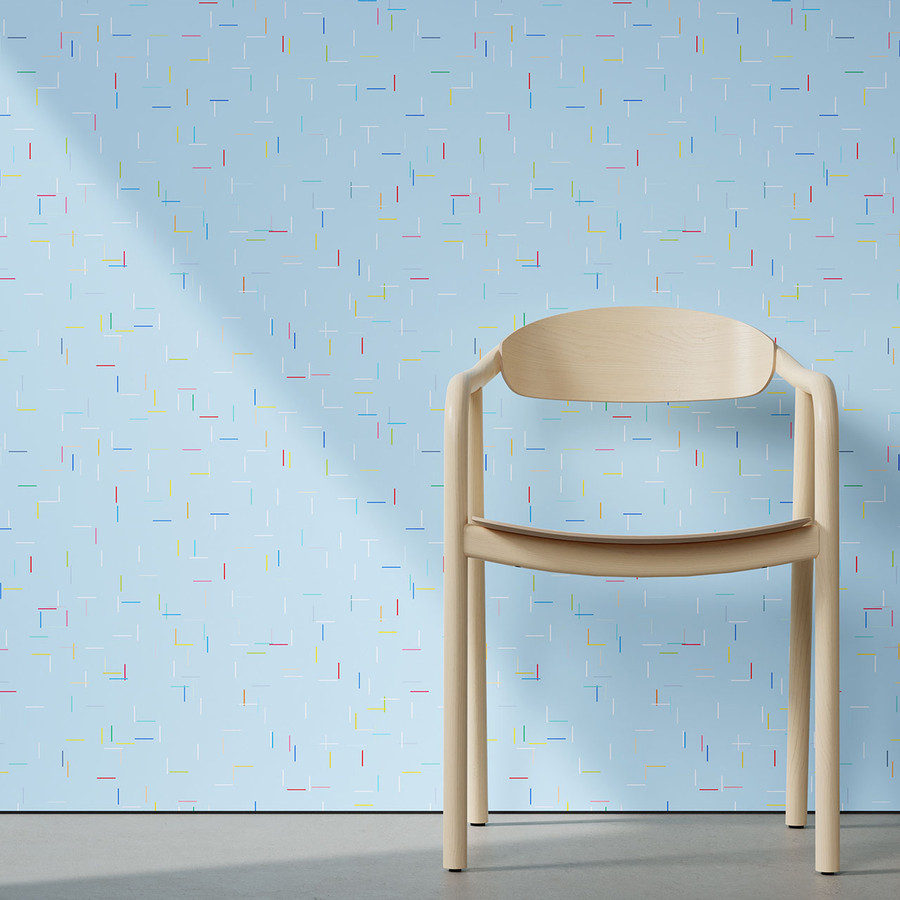 Designtex: pale blue speckled wallcovering behind a timber chair