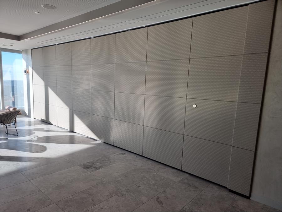 A corridor wall panelled in grey embossed leather