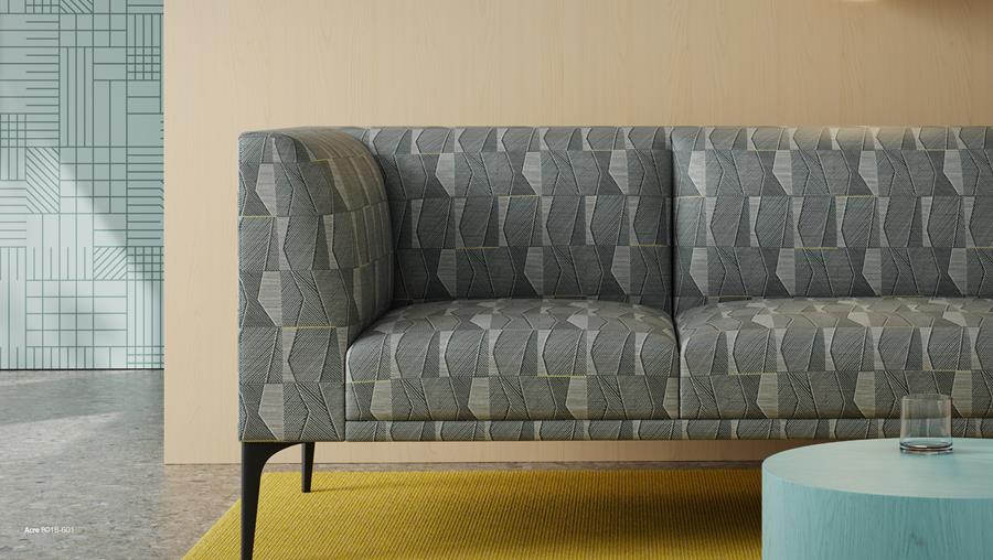Sofa upholstered in patterned Designtex Acre on a yellow rug