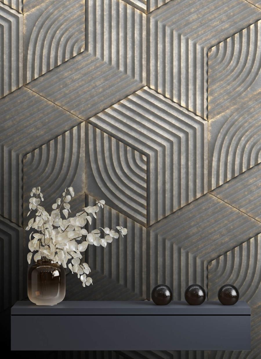 Newmor Industrialis Argento: a black and gold geometric wall behind a vase