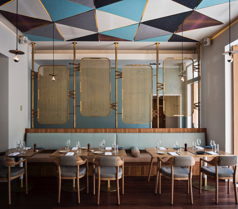 A restaurant with leather chairs under a painted ceiling