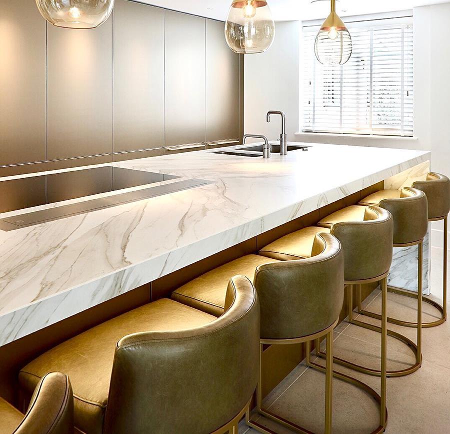 A kitchen bar with olive leather stools