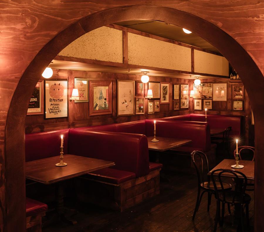 An arched restaurant with red leather booths