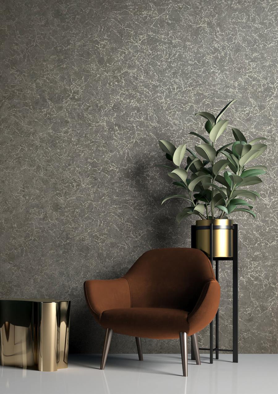 A grey textured wall with a leather armchair and a plant