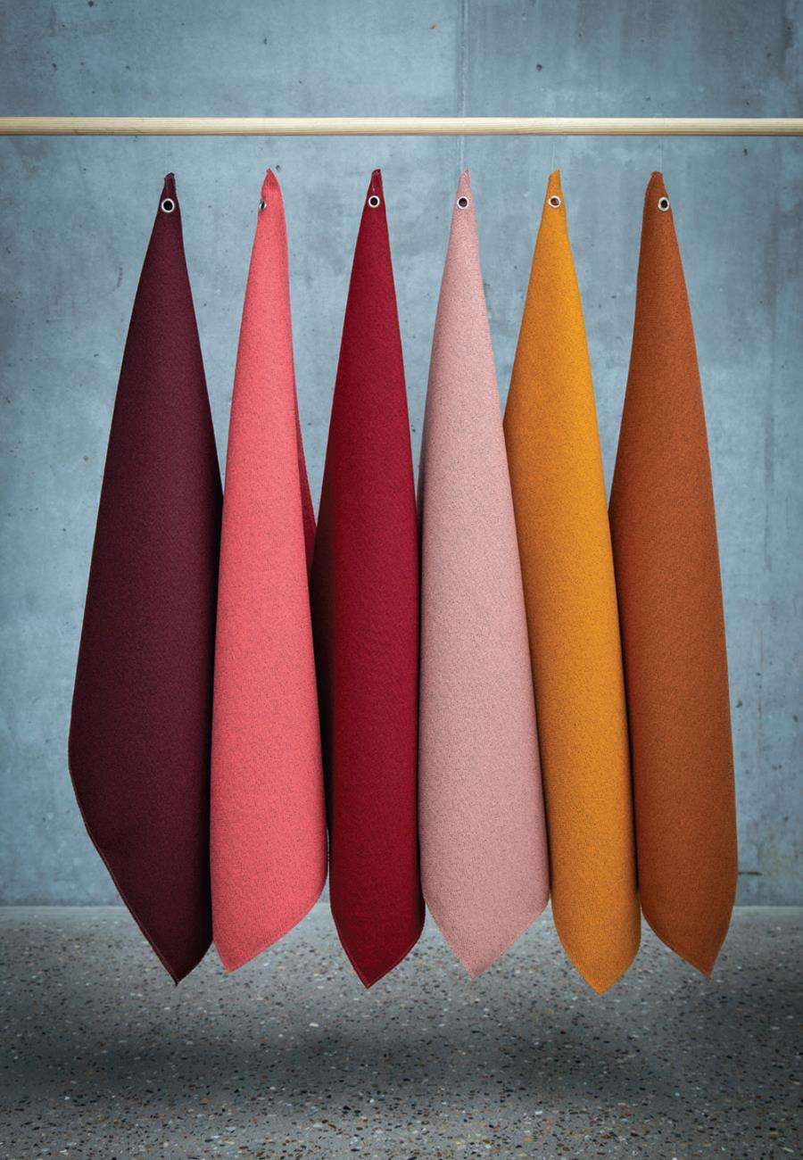Hanging lengths of Gabriel fabric in red, pink and orange