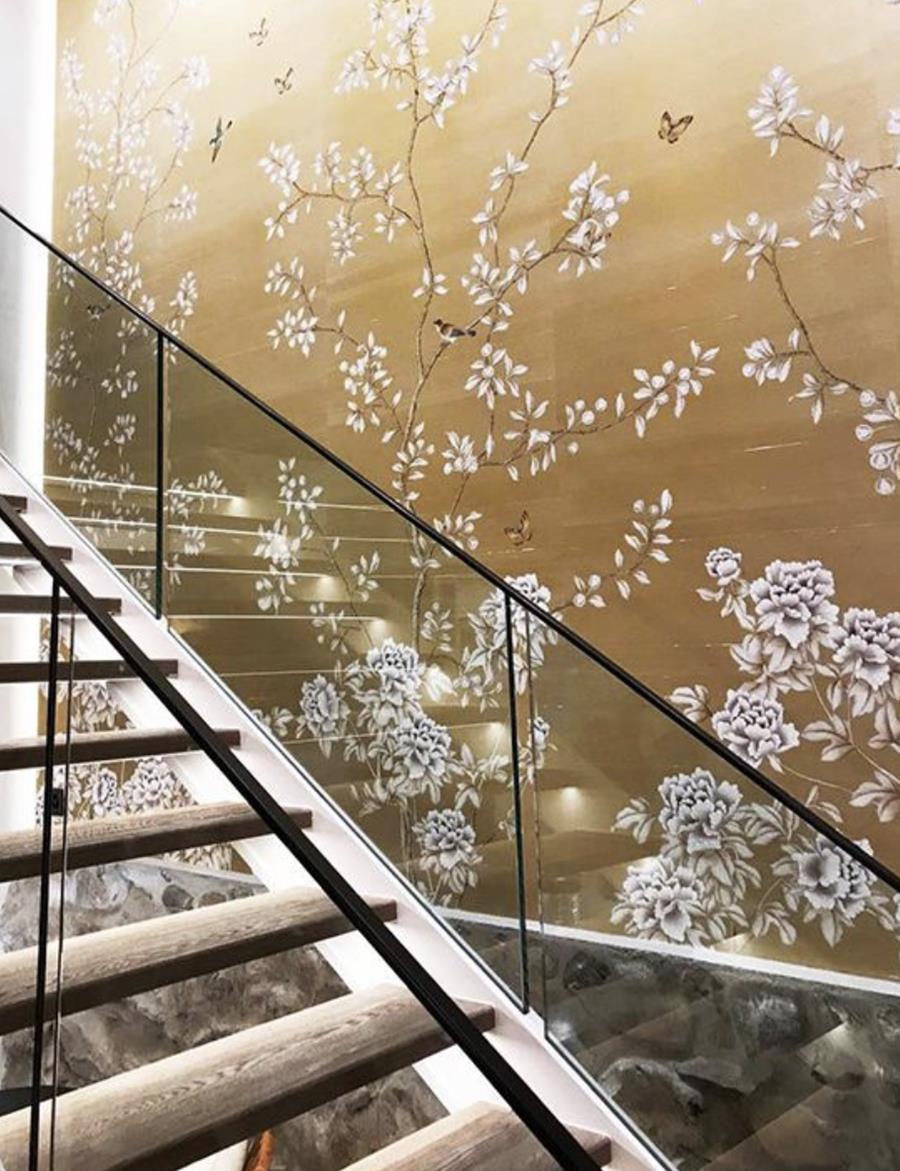 Misha Chinese Winter Garden: white blossom on gold beside a glass staircase