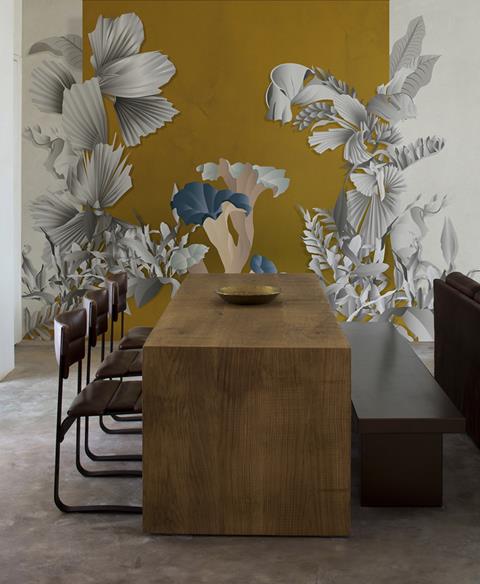 Dining room with large white flowers painted on a grey wall