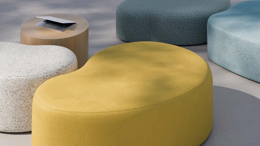 Lounge with a round yellow ottoman and blue seating