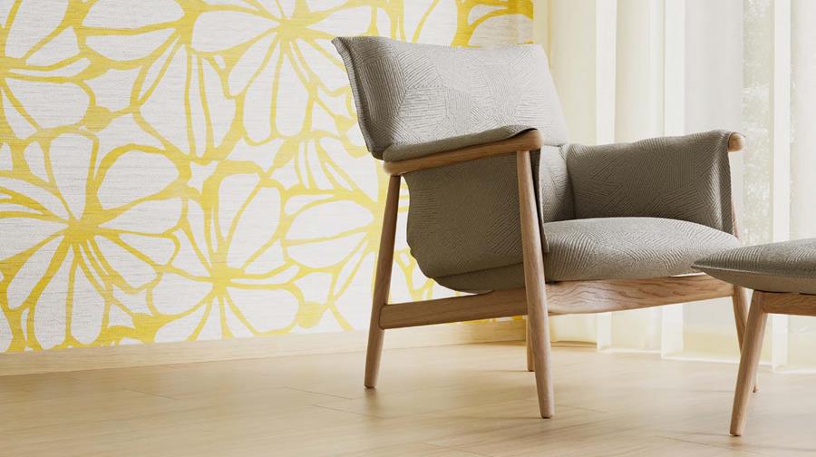 Lounge chair in front of a yellow leaf-pattern Designtex fabric