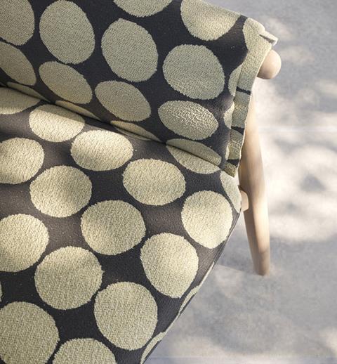 Navy Designtex fabric with large gold dots on a chair
