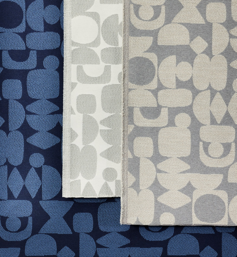 Layered Designtex fabrics in navy and cream geometric patterns