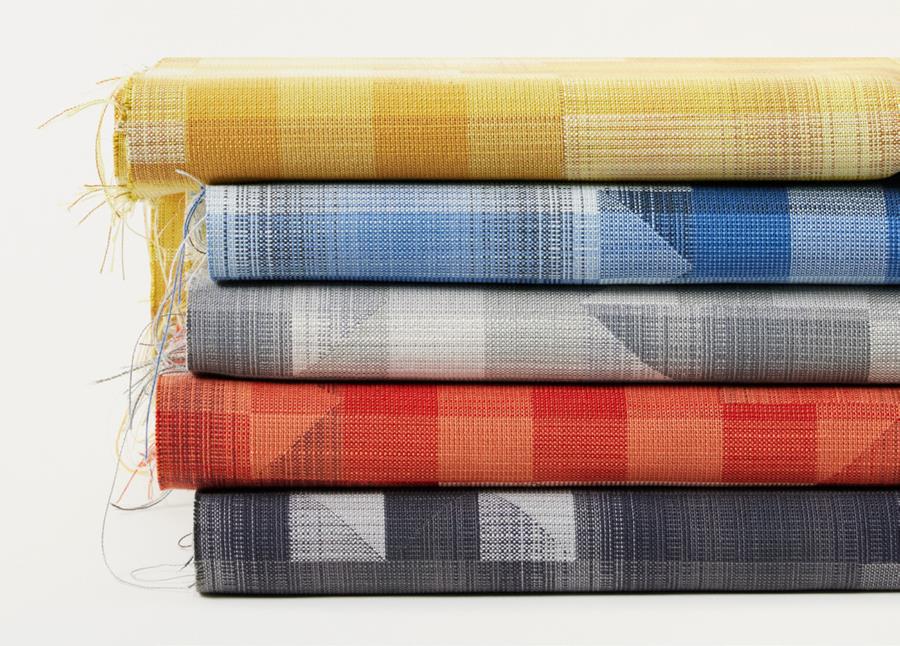 A stack of folded check fabrics in yellow, red and blue