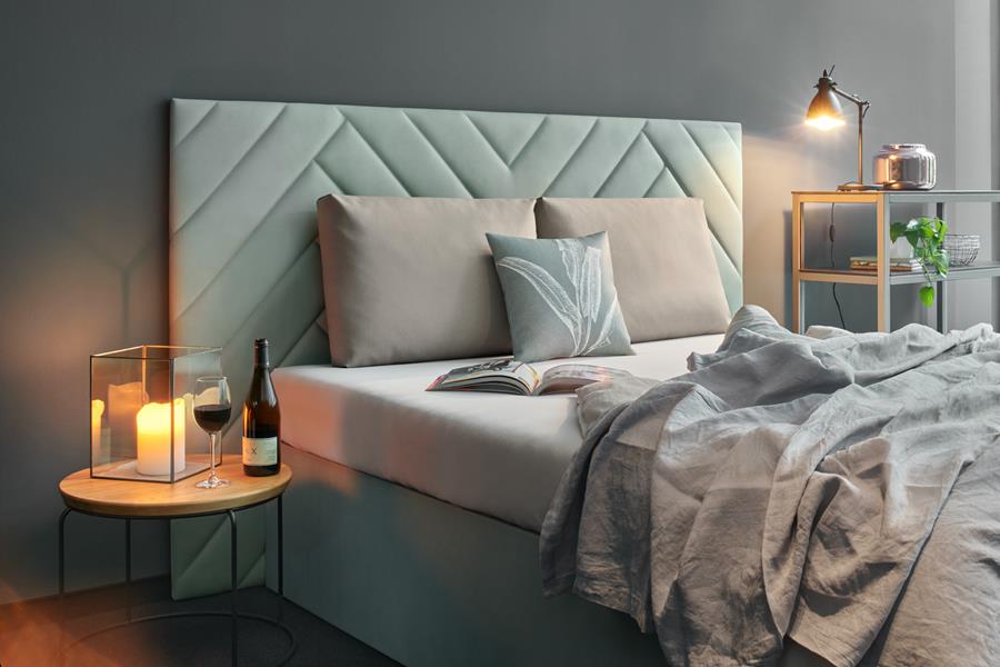 Bedroom with a padded sage skai headboard