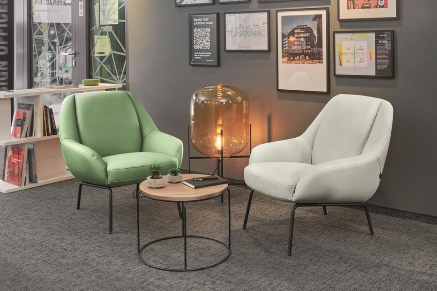 Green and cream armchairs in skai beside a small round table