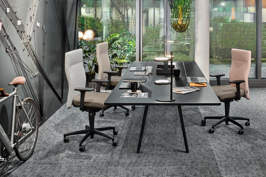 Workspace with skai office chairs beside a wall of windows
