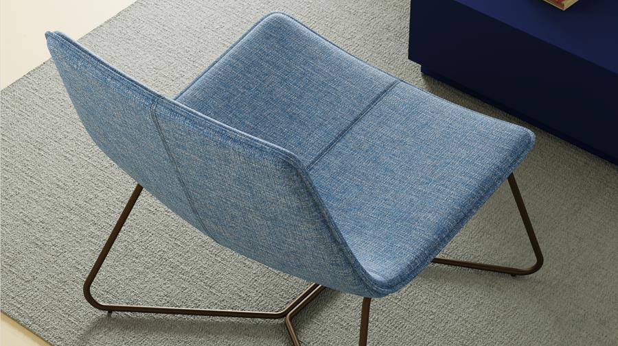 Blue lounge chair upholstered in Designtex Marl