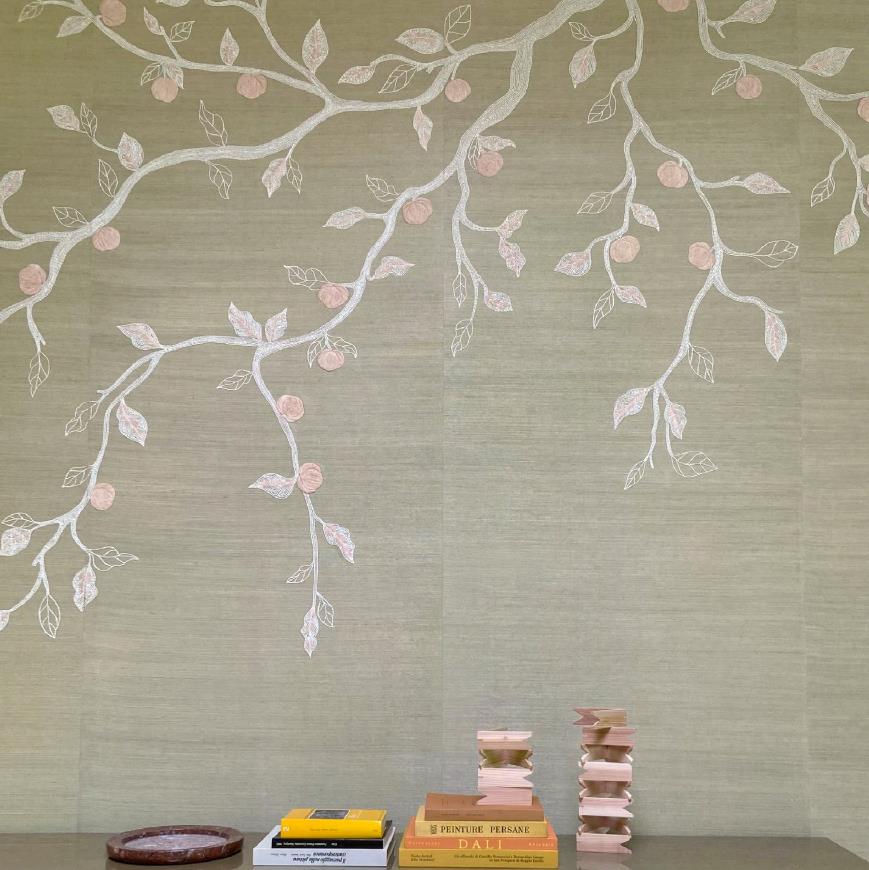 Pale wall with embroidered branches above a low shelf