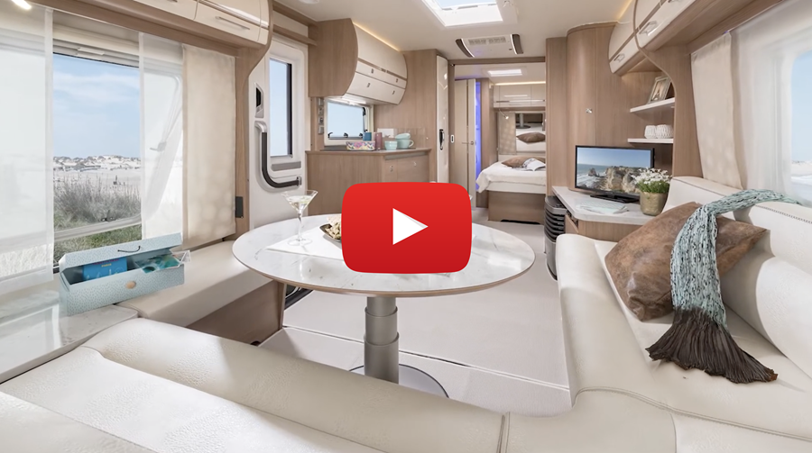Video still: a cabin interior with skai seating, with a play button