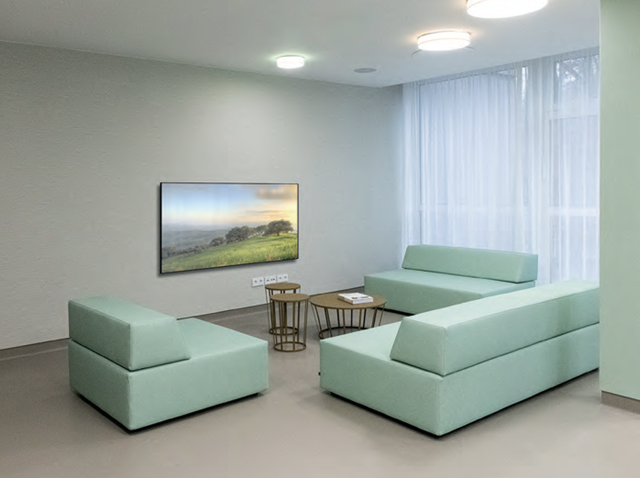 Healthcare lounge with mint green modular seating