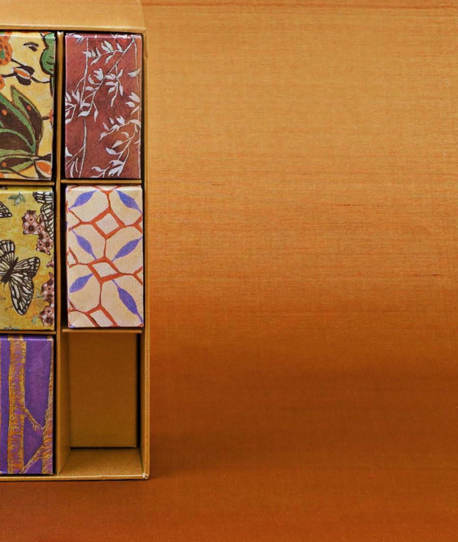 A wall in burnt orange silk beside shelves of patterned panels