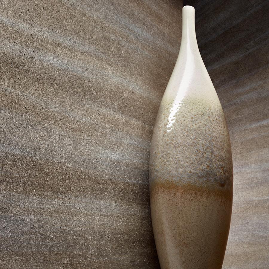 Apex: metallic textured wallcovering behind a tall ceramic vase