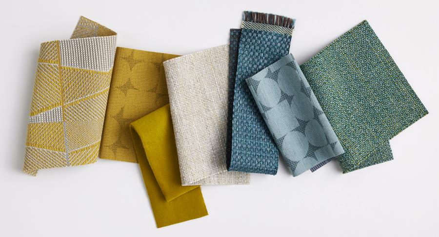 Designtex and West Elm fabric samples fanned out in mustard, blue, green and grey