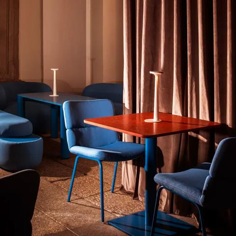 Bar Adrenalina, Milan: blue upholstered chairs at a table