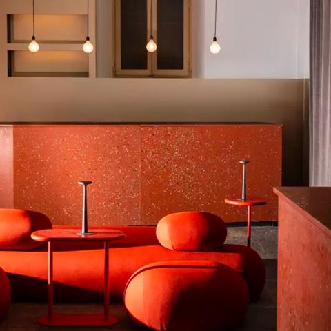 Bar Adrenalina, Milan: orange upholstered seating