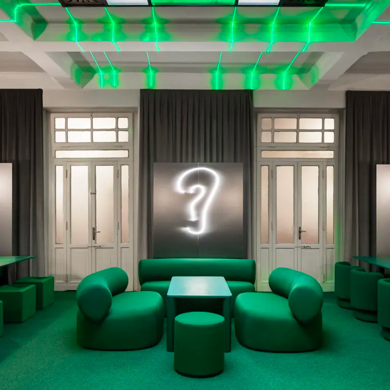 Bar Adrenalina, Milan: green upholstered seating under green lights