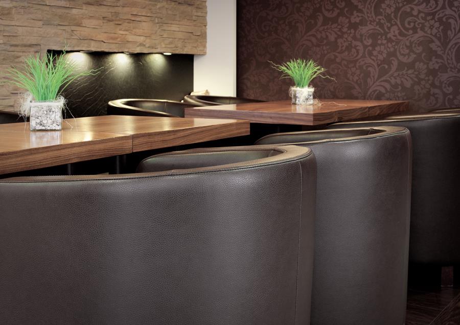 Restaurant booths upholstered in dark brown skai vinyl