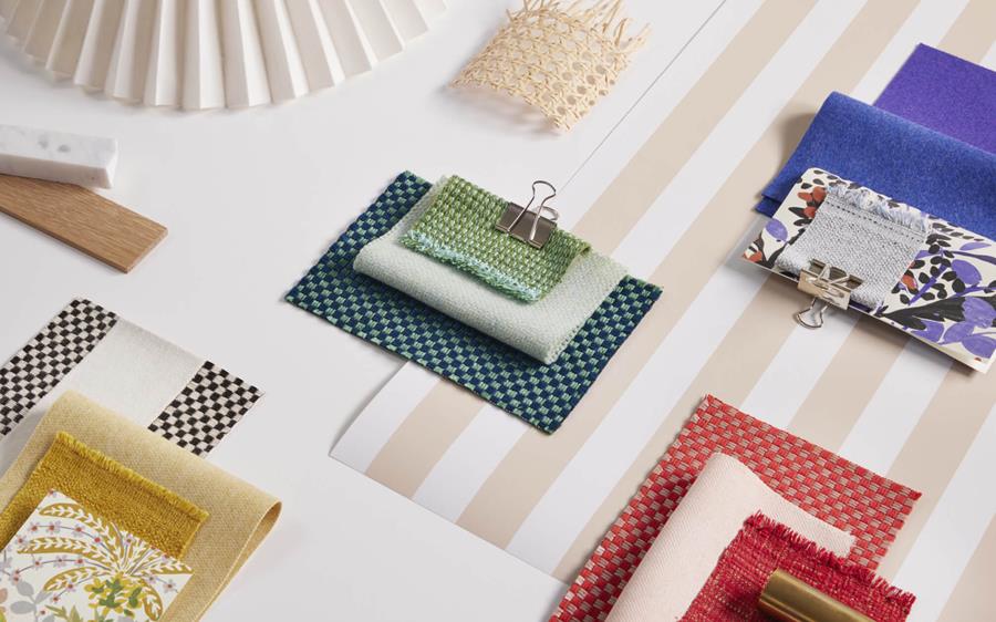 Flat lay of Designtex outdoor fabric samples in stripes, checks and solids