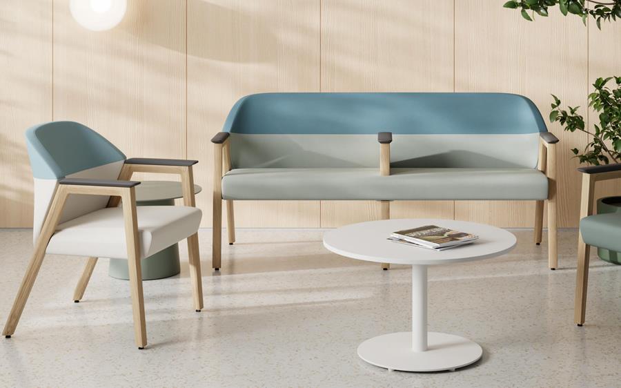 Lounge seating upholstered in blue and grey with a round side table