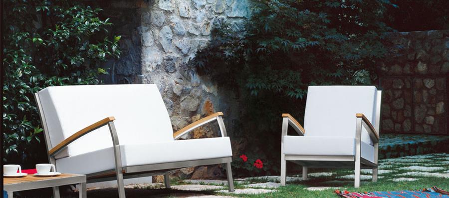 White outdoor armchairs in a garden courtyard