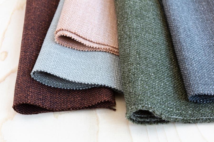 Folded Svensson Rami fabrics in burgundy, blue, green and pink