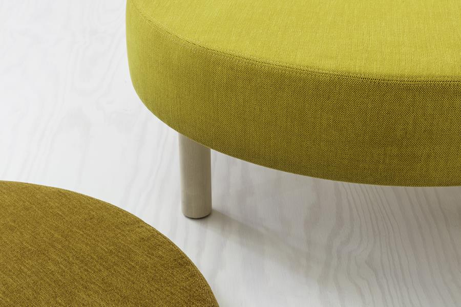 Round ottomans upholstered in yellow and mustard Svensson fabric