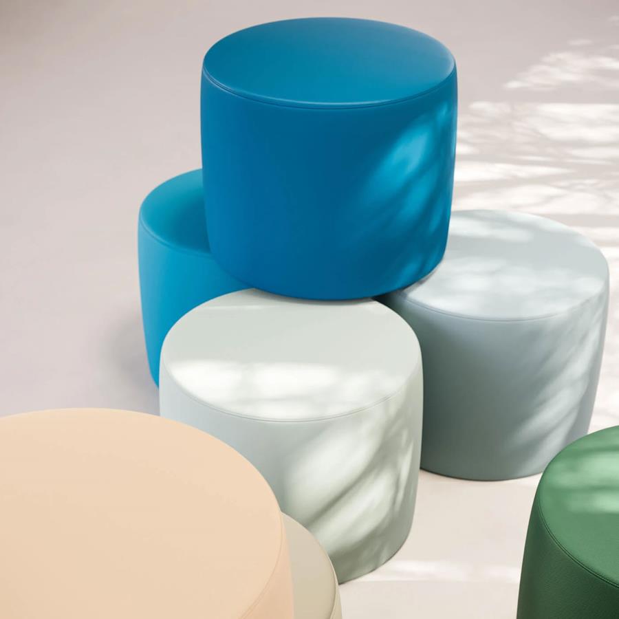 Round upholstered ottomans in blue, pale green and cream