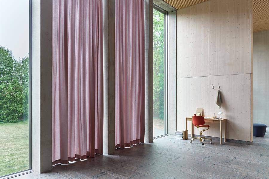 Mauve Svensson curtains along a tall window wall