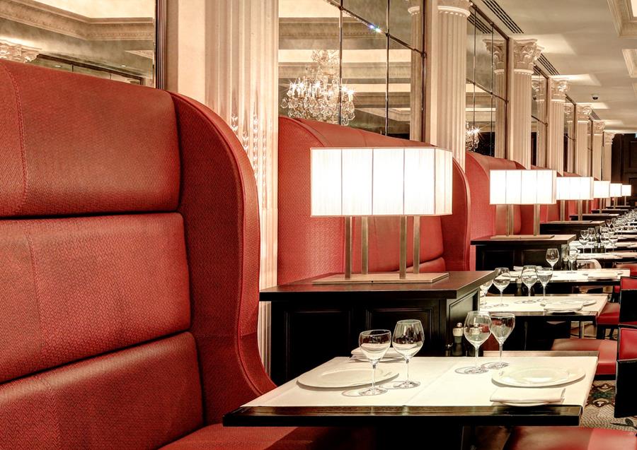 A restaurant with red leather banquettes