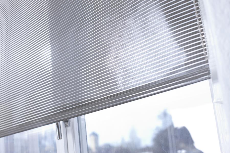 Svensson roller blind half lowered at a window