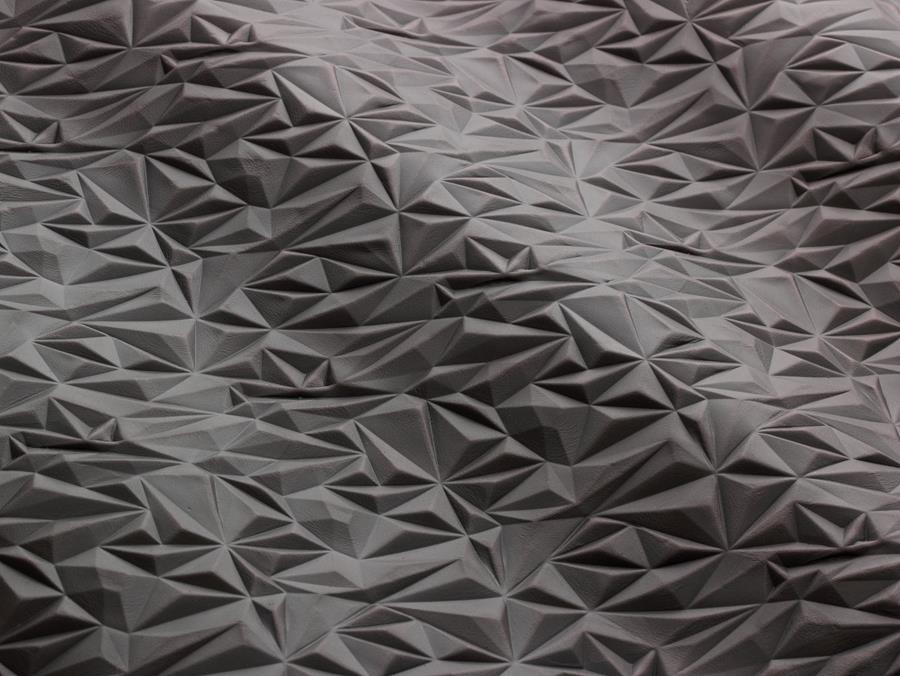 Close-up of grey leather with a geometric emboss